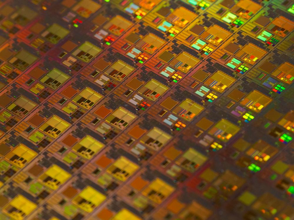 Close-up of a silicon wafer with colorful dies